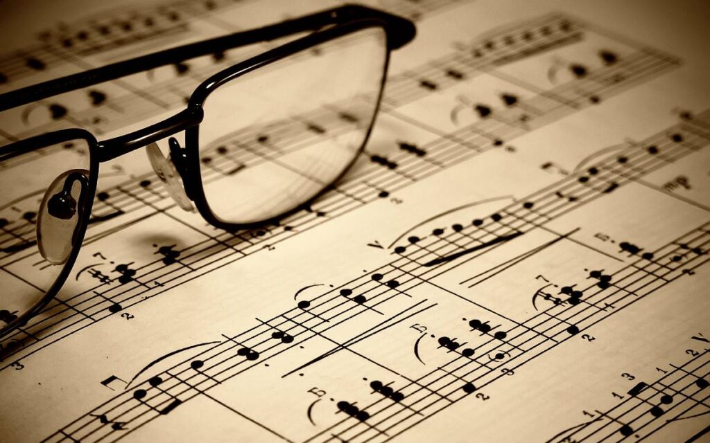 A pair of glasses on music sheet