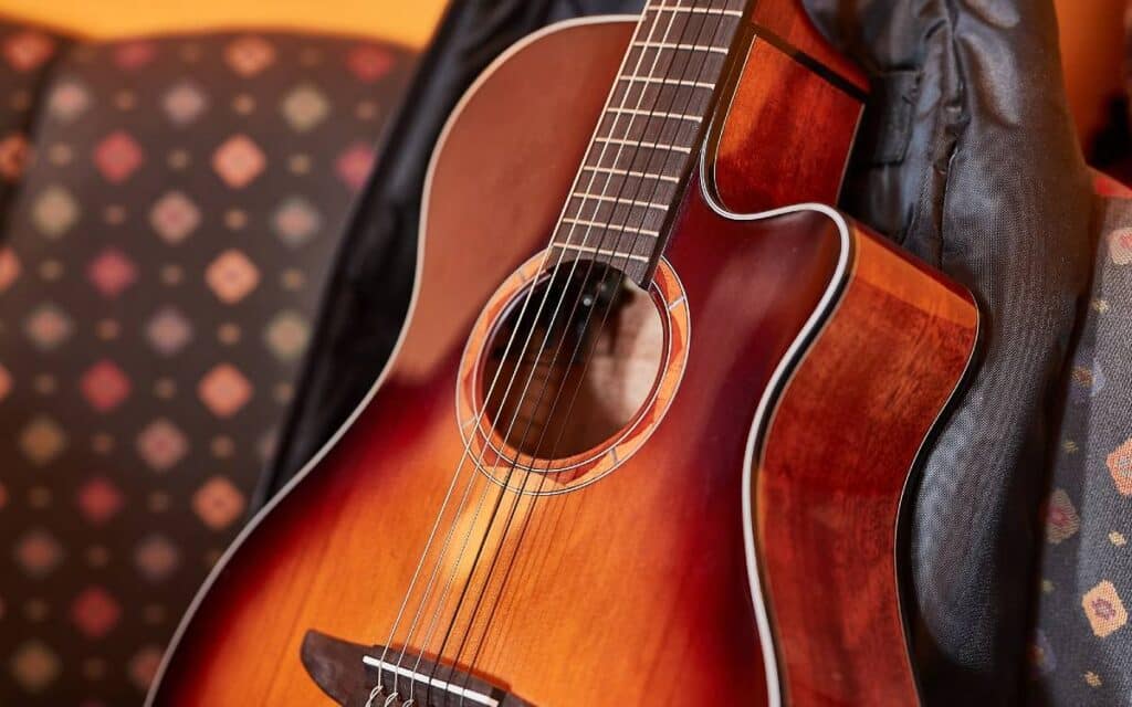 Acoustic guitar leaning on couch