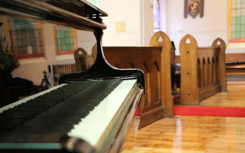 Black grand piano in a church