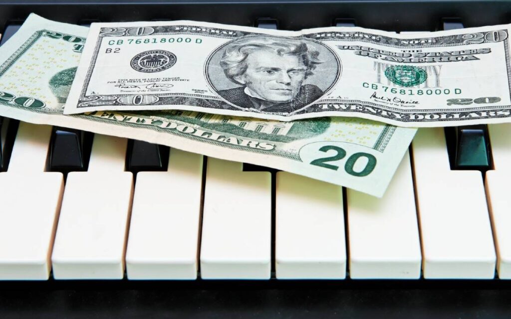 Dollar bills on keyboard 1200x750