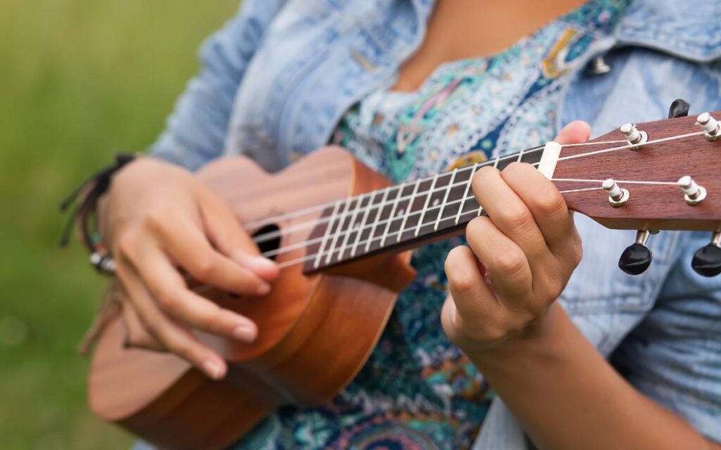 Girl playing ukulele outdoor