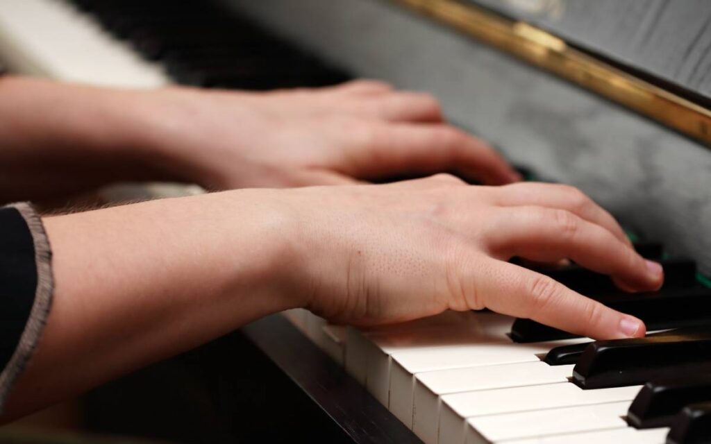 Hands playing the piano