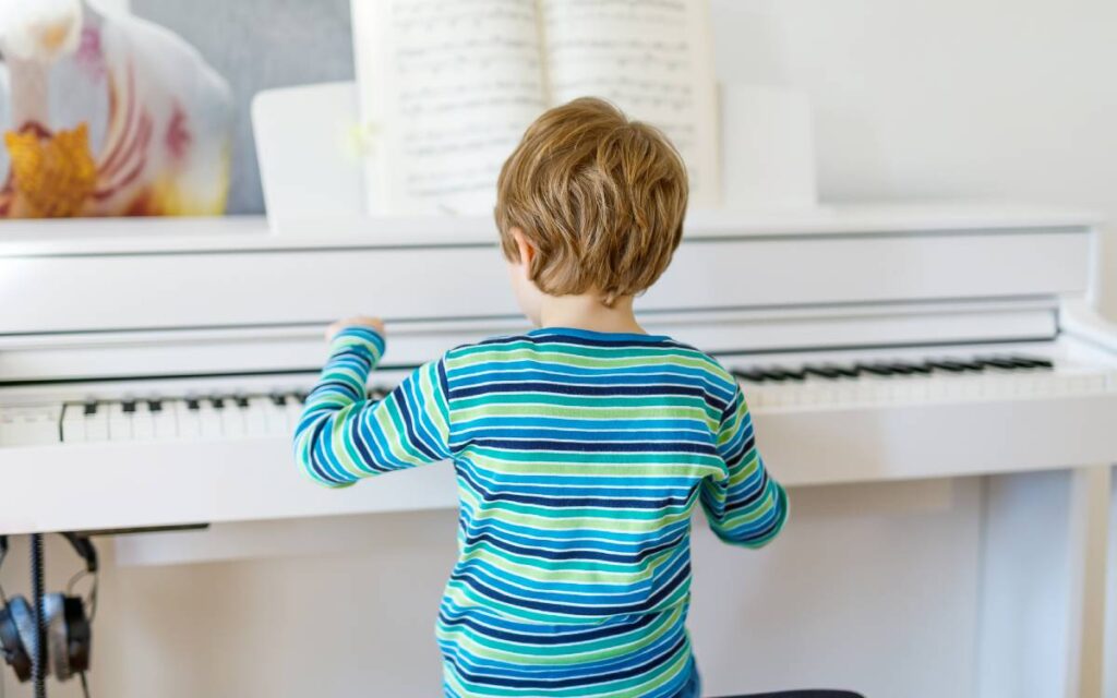 Little boy playing piano in the living room
