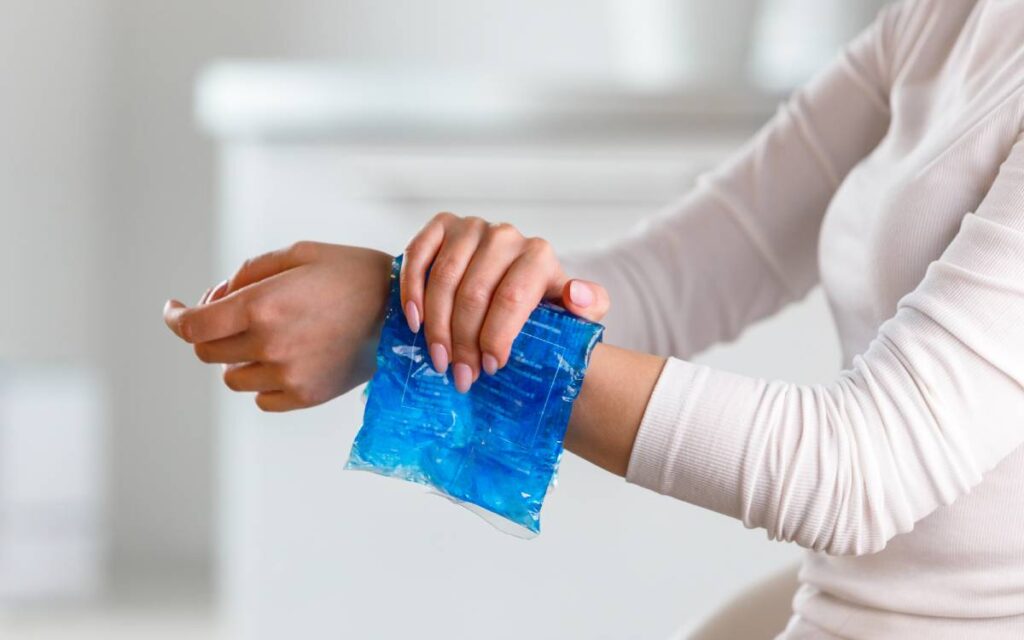 Woman applying cold compress on her wrist