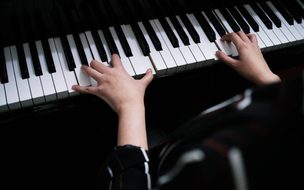 Woman's hand playing the piano