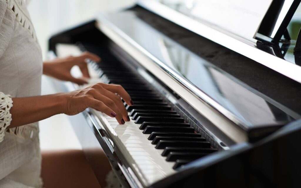 Hands of a woman playing the piano