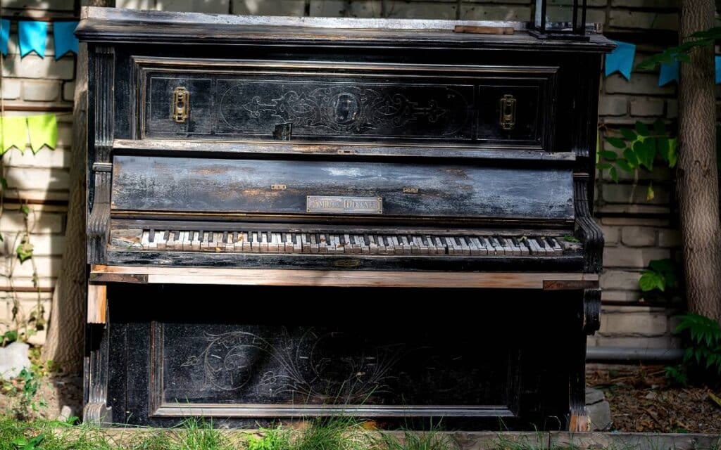 Old vintage piano stands outside