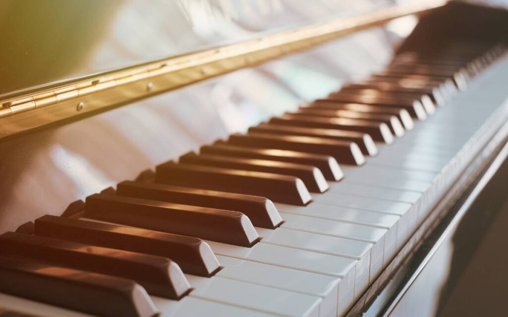 Piano keys illuminated by sunlight