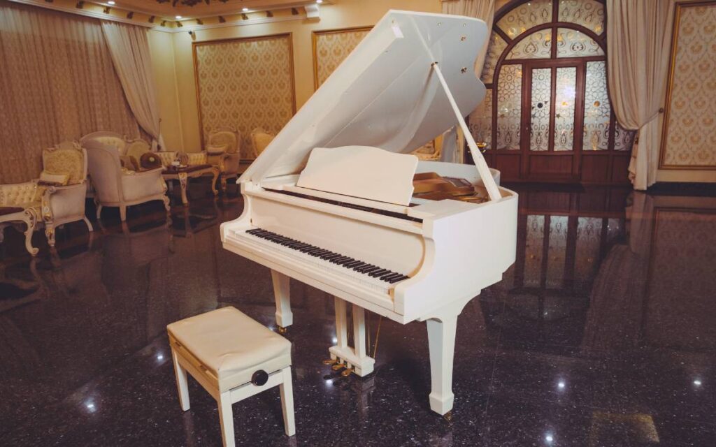 White grand piano in the center of a room