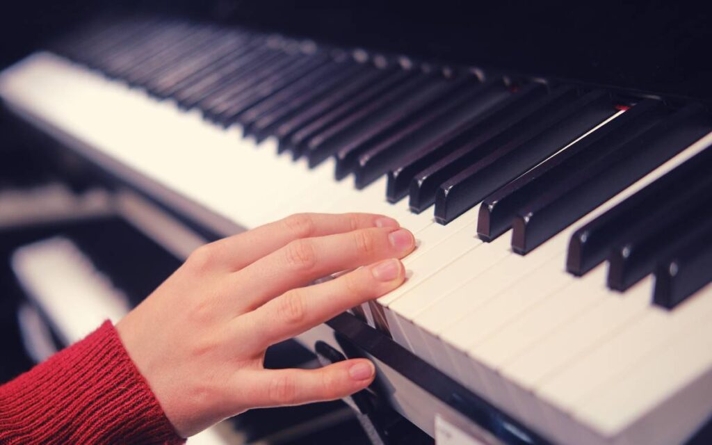 Woman's hand on a digital piano
