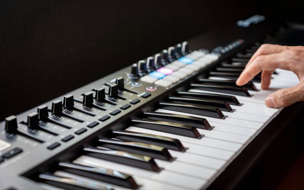 A hand on synthesizer keys