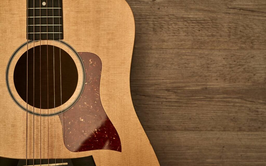 Acoustic guitar with red pick guard