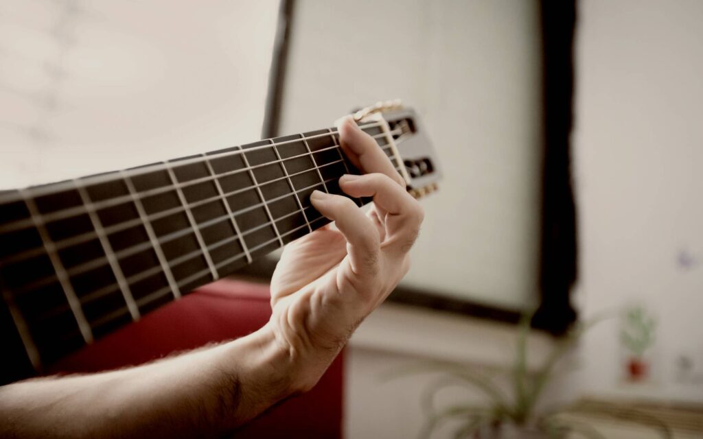 Close up of hand playing guitar