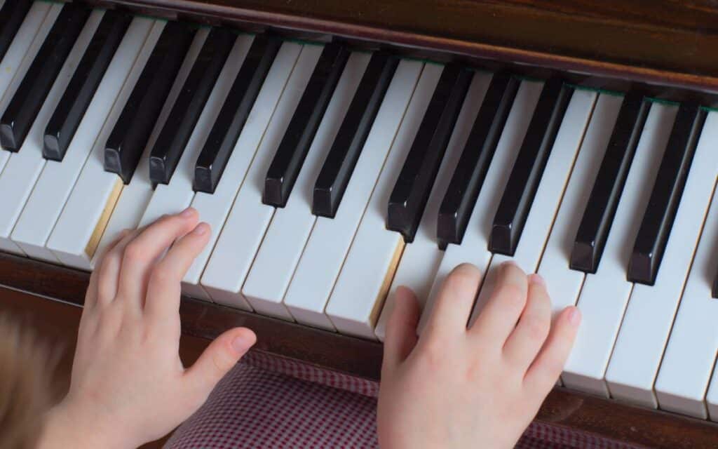 Child's hands practicing piano