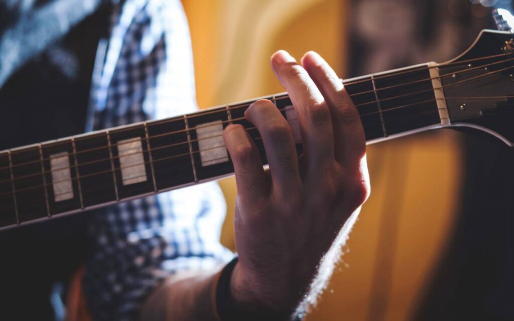 Close up of a hand playing guitar