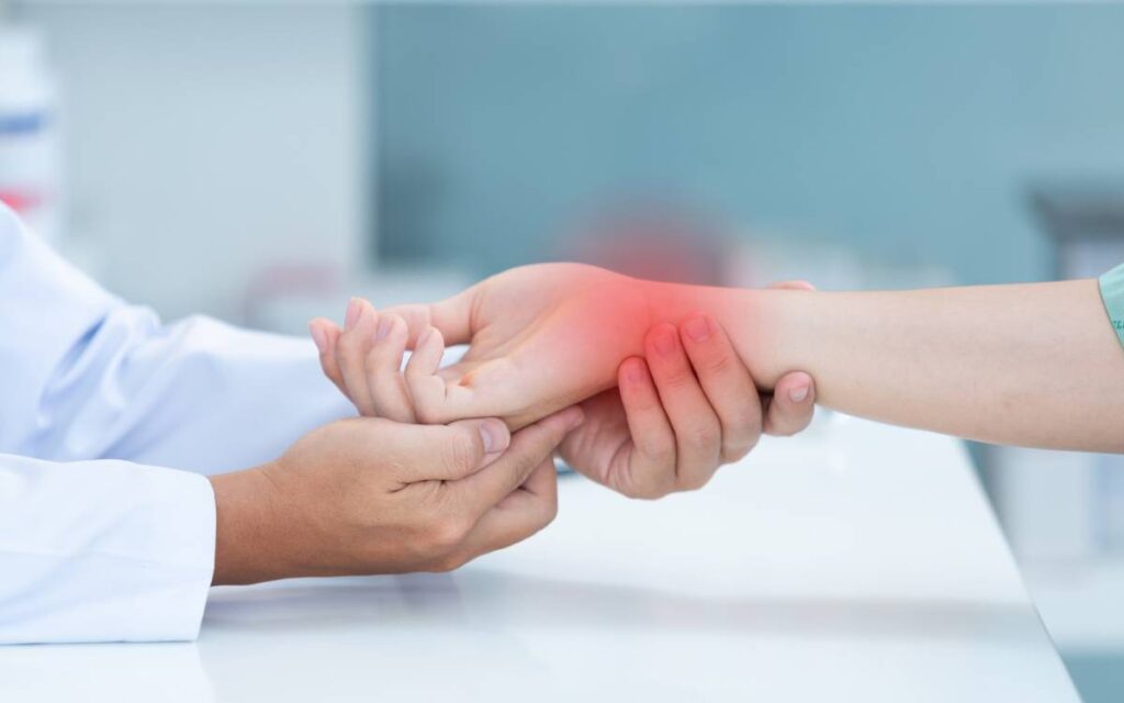 Close up of doctor's hands examining patient's wrist