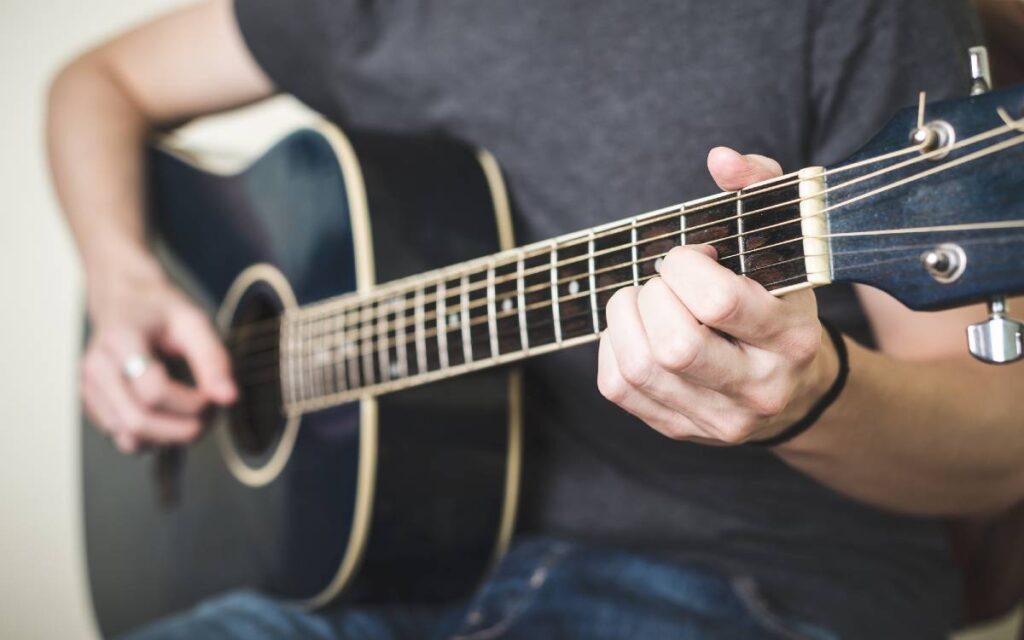 Close up of hands playing guitar