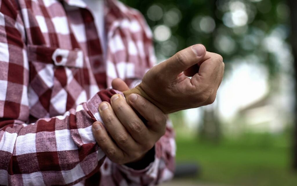 Close up of man holding his wrist