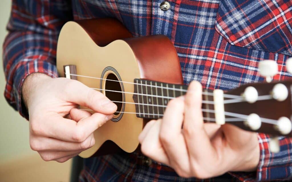 Close up of man playing ukulele