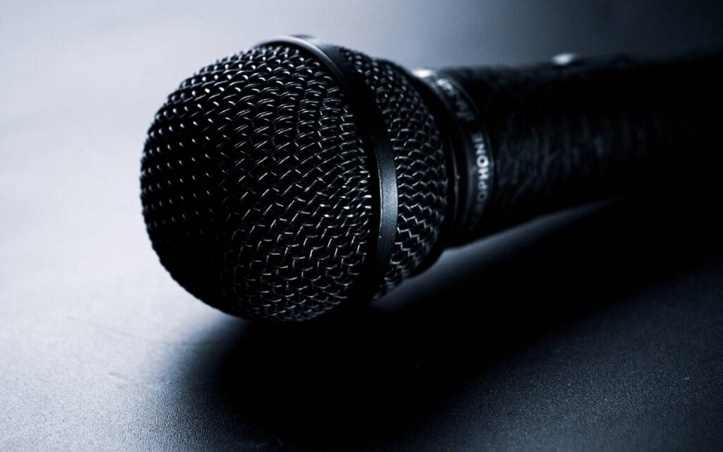 Close up of microphone on a black background