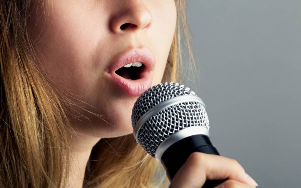 Close up of  woman holding a microphone and singing