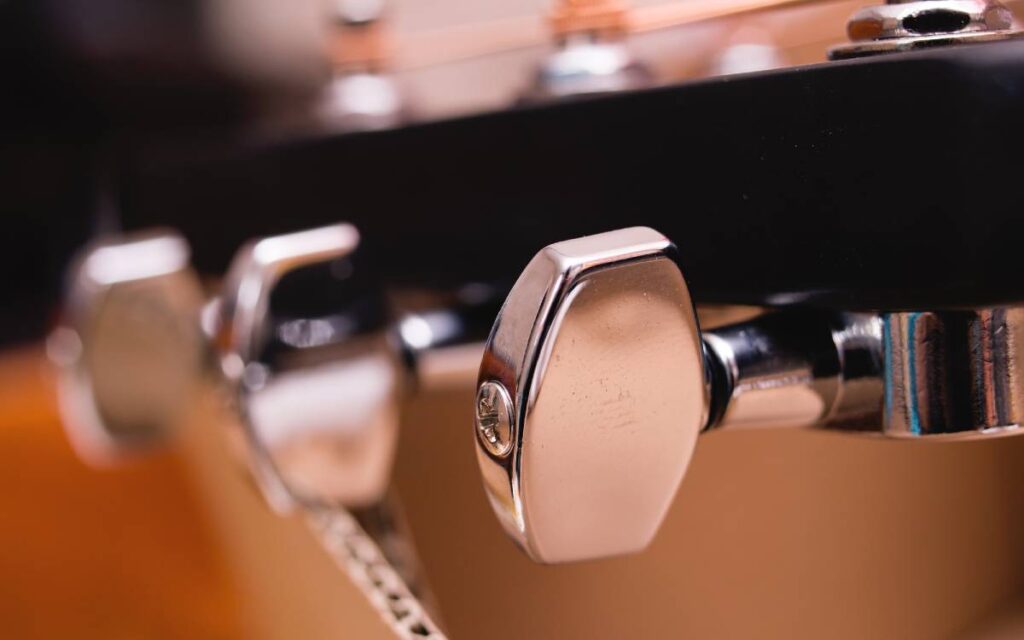 Close up view of acoustic guitar tuning pegs