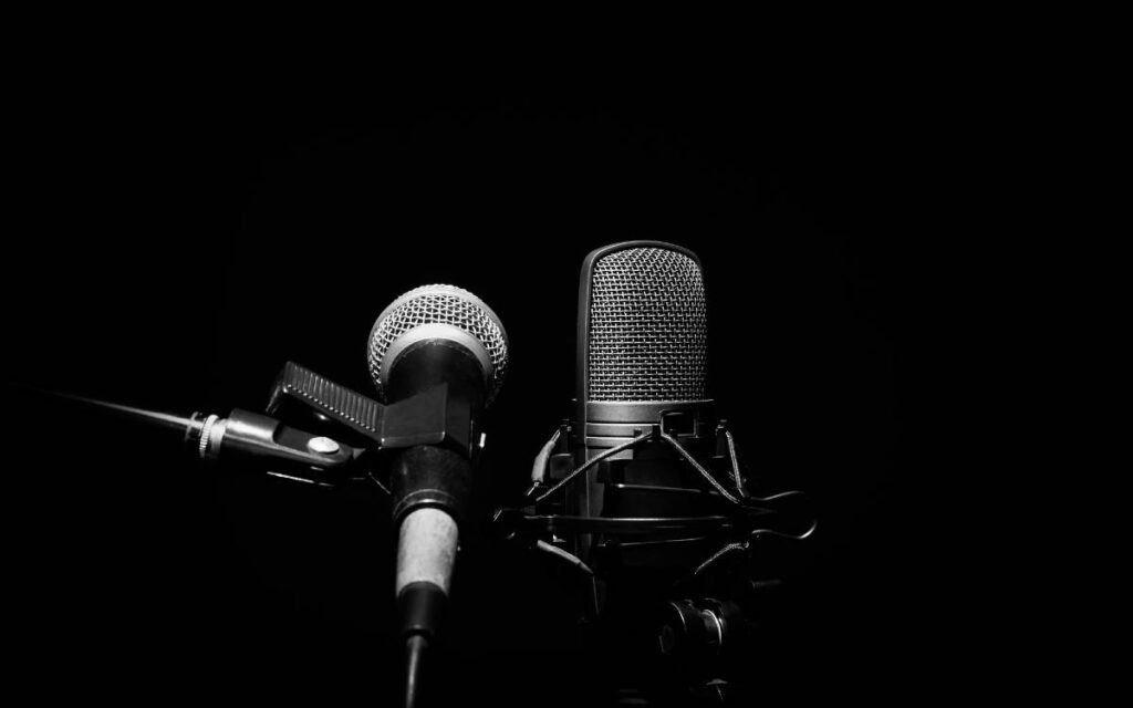 Dynamic microphone and condenser microphone on black background