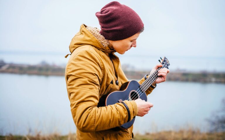 Let it be ukulele chords_man playing ukulele near a lake