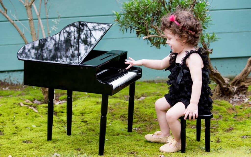 Little girl playing toy piano