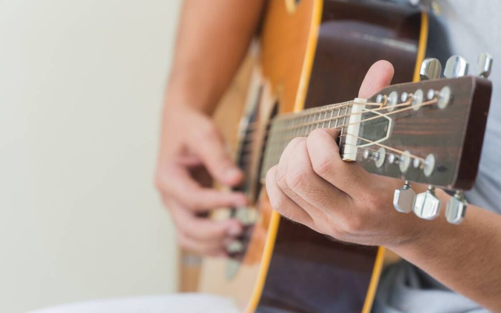 Male hands playing guitar