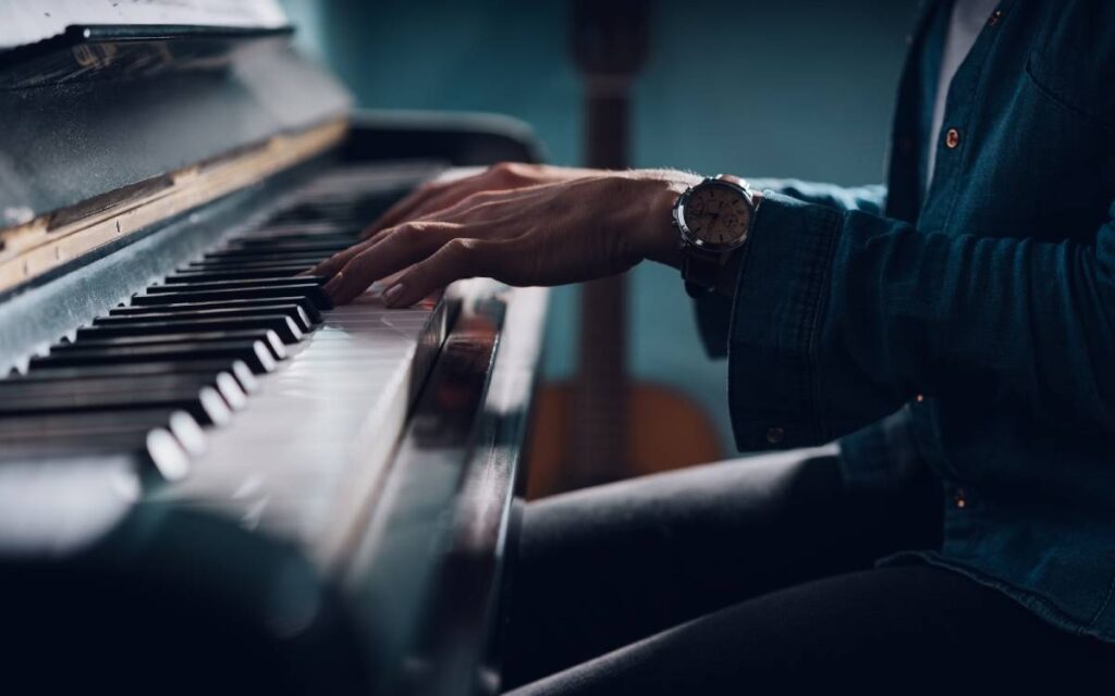 Man playing the piano wearing formal attire