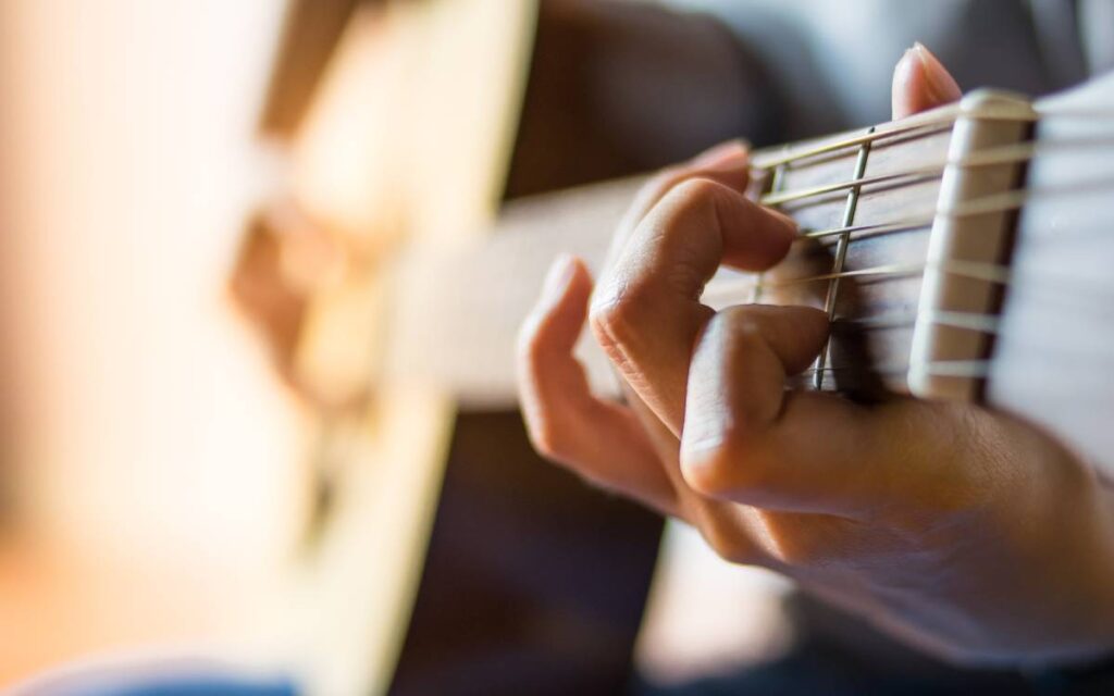 Man's hands playing guitar