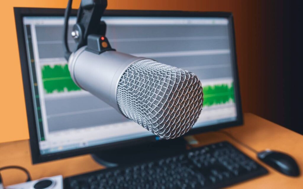Microphone with audio waves on a computer screen background