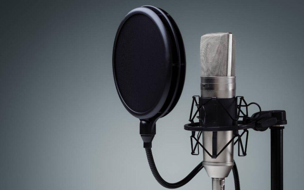 Microphone with pop filter on gray background