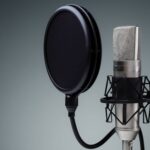 Microphone with pop filter on gray background