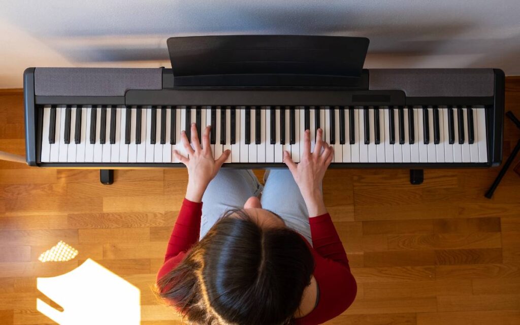 Top view of woman playing the piano