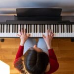 Top view of woman playing the piano