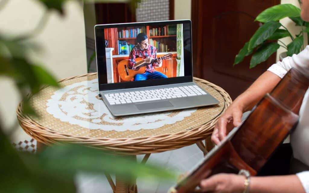 Woman learning guitar online 1200x750