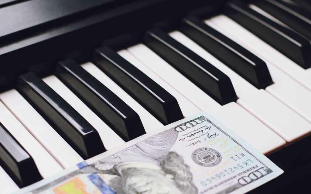 $100 bill on piano keys