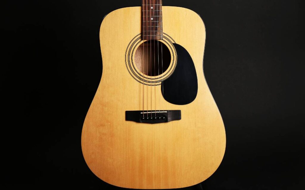 Acoustic guitar on black background