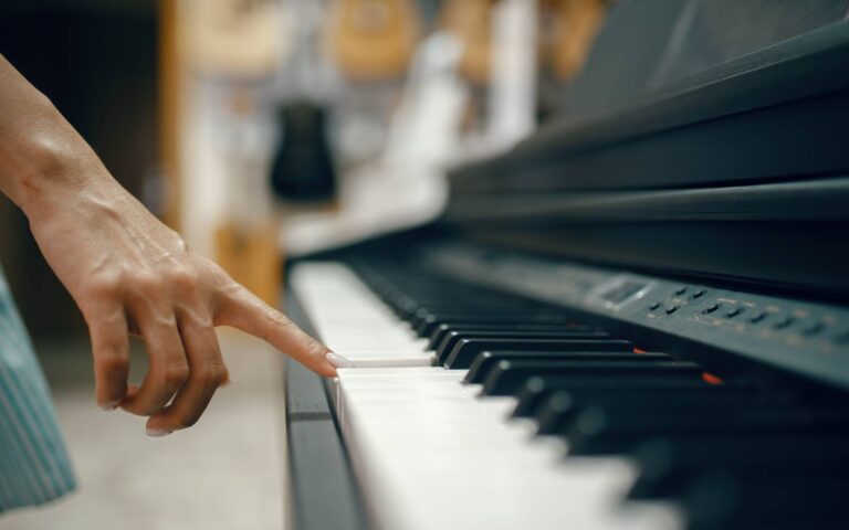 Best digital piano brands_girl pressing piano key with her index finger