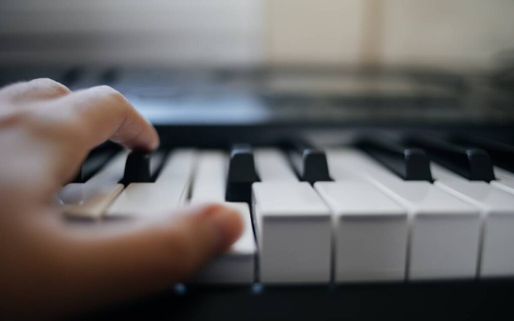 Close up of a hand on piano keys