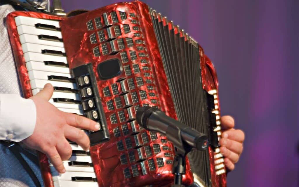 Close up of hands playing accordion, which is an estremely difficult instrument to play
