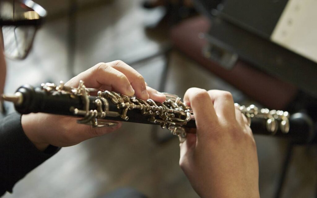 Close up of man's hands playing the oboe