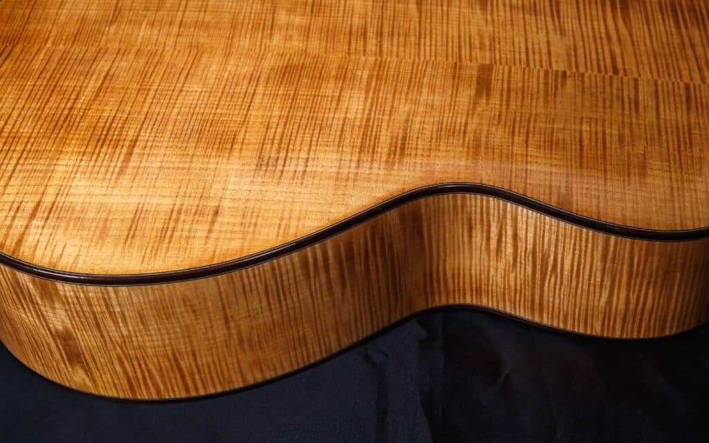 Close up view of an acoustic guitar's back and side