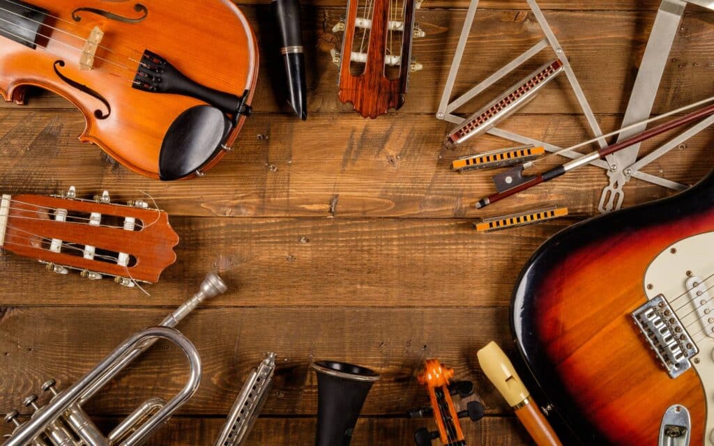 Different musical instruments on wooden background