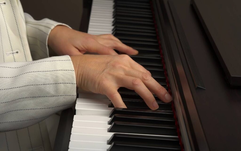 Female hands playing the piano