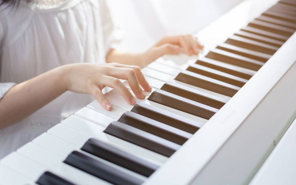 Girl in white playing piano