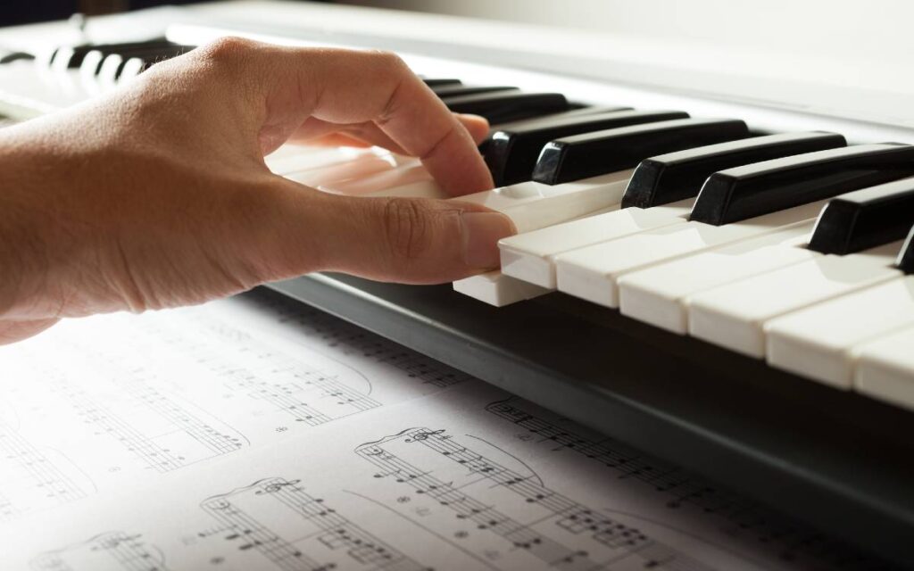 Hand on piano keys