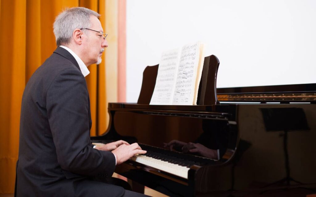 Musician reading music sheet and playing piano